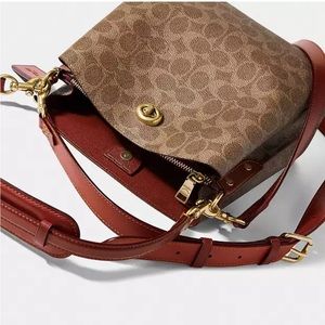 Never used Coach bag. Paper still inside. Excellent condition